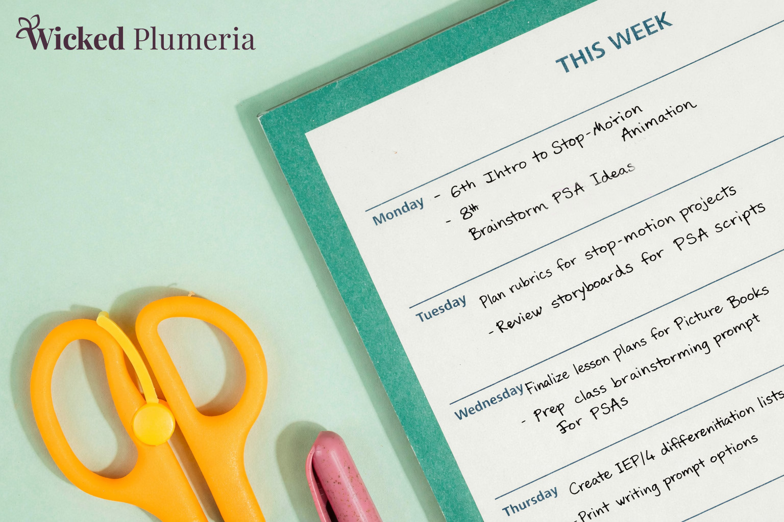 Planning page with notes from a teacher, yellow scissor handles, and partial view of a pink pen. Wicked Plumeria branding in top left corner.